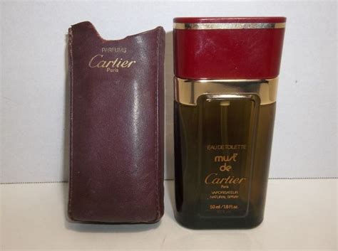 cartier perfume in leather case.